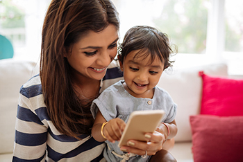 Mom with her child reading leaving a review for Jillian Prather Family Dentistry