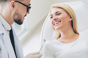 Female patient getting an oral cancer screening like they perform at Cooley Smiles in Everett, WA