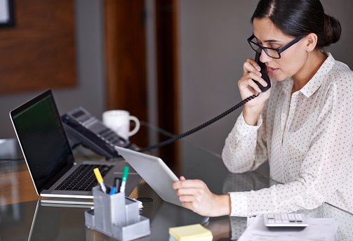 A receptionist on the phone