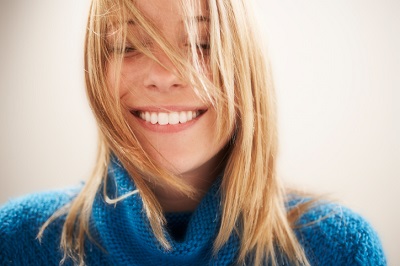 A dental patient smiling after getting air abrasion at her dentist in Owasso, OK. 