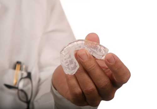 Doctor holding Mouthguard from Cooley Smiles in Everett, WA