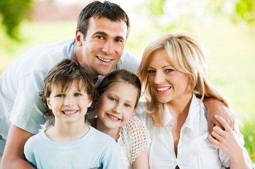 Family of smiling dental patients at Timothy H. Kindt, DDS.