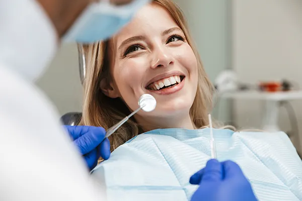 Relaxed patient waiting in a dental chair for her dentist to begin her routine dental exam