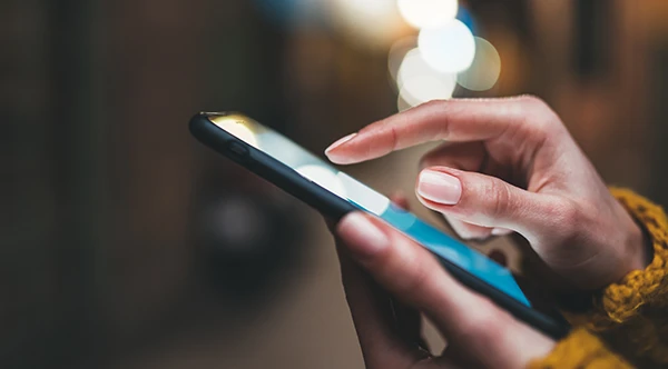 Close up of hands scrolling through patient information a smart phone
