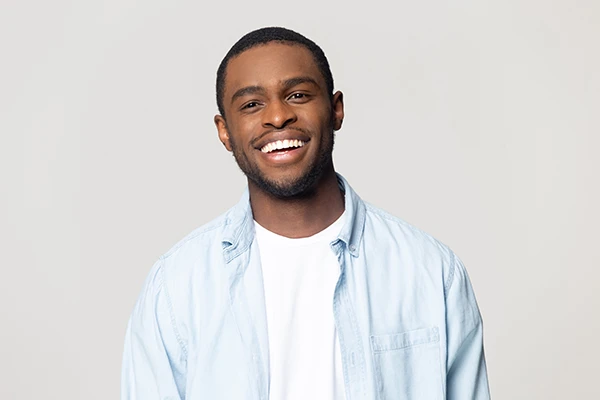Handsome Black man with a fabulous smile from cosmetic dentistry treatment at Hoffman Dental in Hillsboro, OR