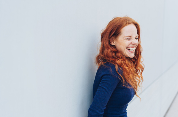 A woman smiling after receiving a smile makeover at Hoffman Dental in Hillsboro, OR