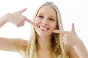 Blonde girl smiling after teeth whitening at Neu Family Dental in East Dundee, IL