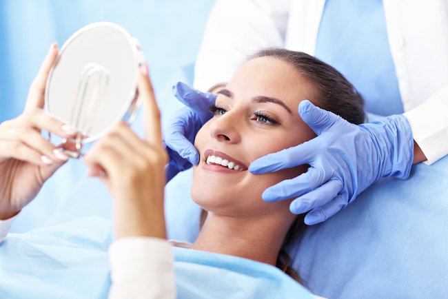 A woman smiling after receiving dental implants at Hoffman Dental in Hillsboro, OR
