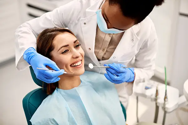 A smiling female patient undergoing periodontal maintenance at Hoffman Dental in Hillsboro, OR A smiling female patient undergoing periodontal maintenance at Hoffman Dental in Hillsboro, OR